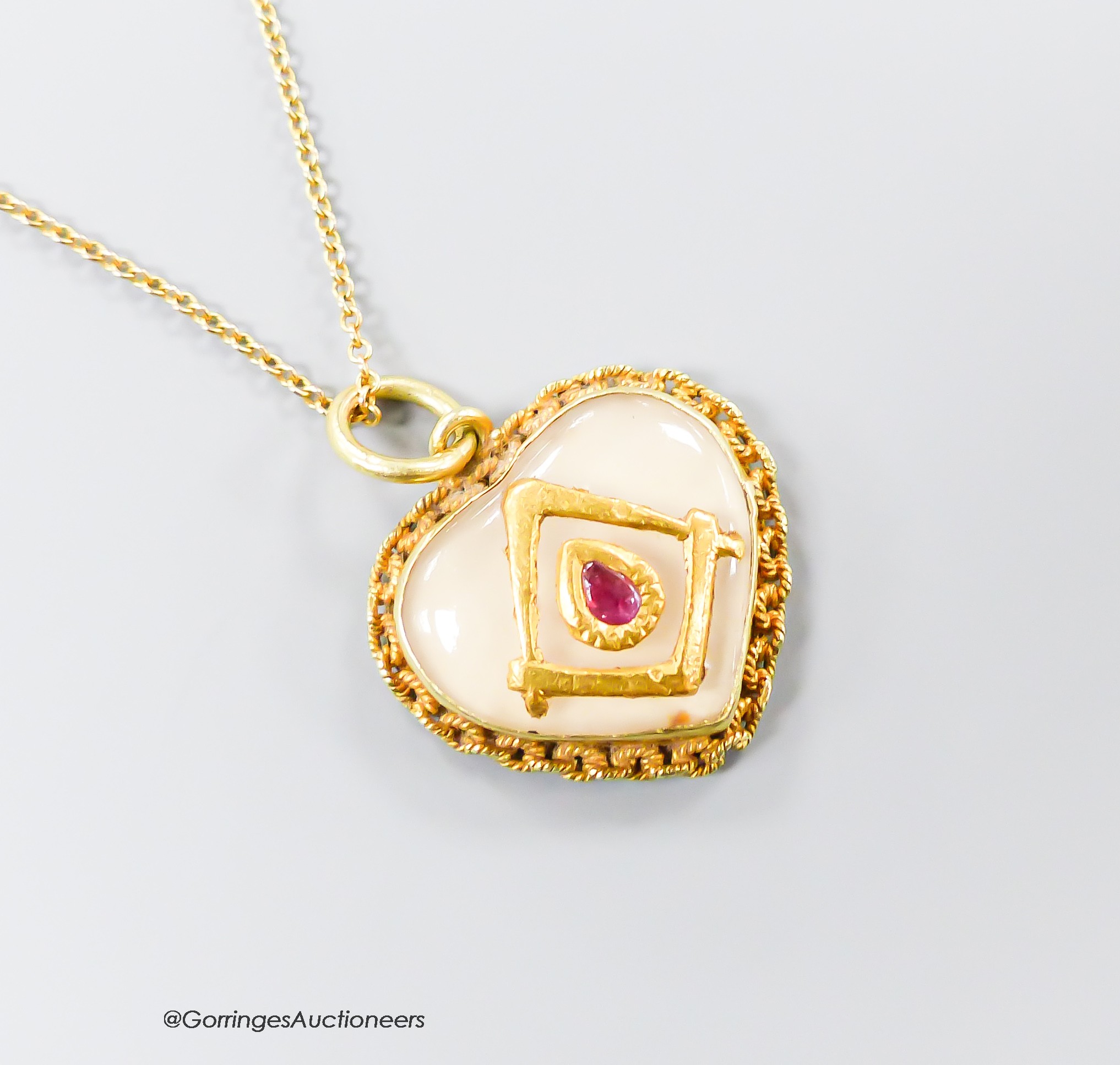 A yellow metal, ruby and paste? set heart shaped pendant with masonic motif, 17mm, on a 9ct chain, gross 4.1 grams.